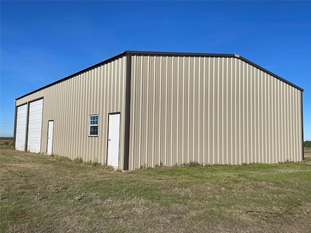 view of outdoor structure featuring a lawn