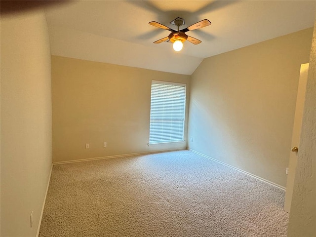 carpeted empty room with ceiling fan and lofted ceiling