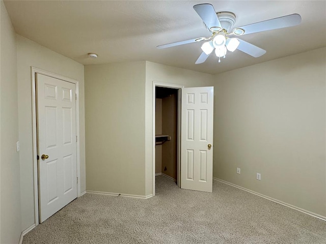 unfurnished bedroom with light carpet, a closet, and ceiling fan