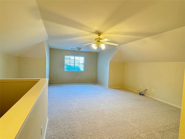 additional living space featuring carpet flooring, ceiling fan, and lofted ceiling