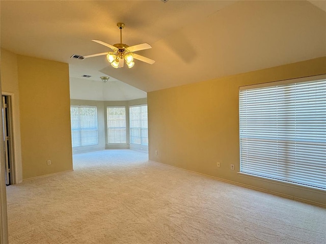 carpeted empty room with ceiling fan and vaulted ceiling