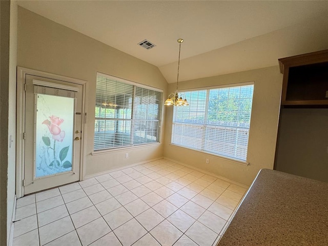 unfurnished dining area featuring a chandelier, vaulted ceiling, and light tile patterned flooring