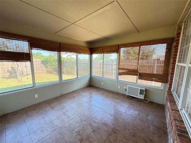 unfurnished sunroom featuring a wall unit AC