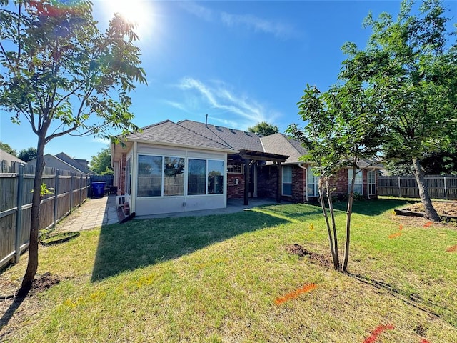 rear view of house with a lawn and a patio area