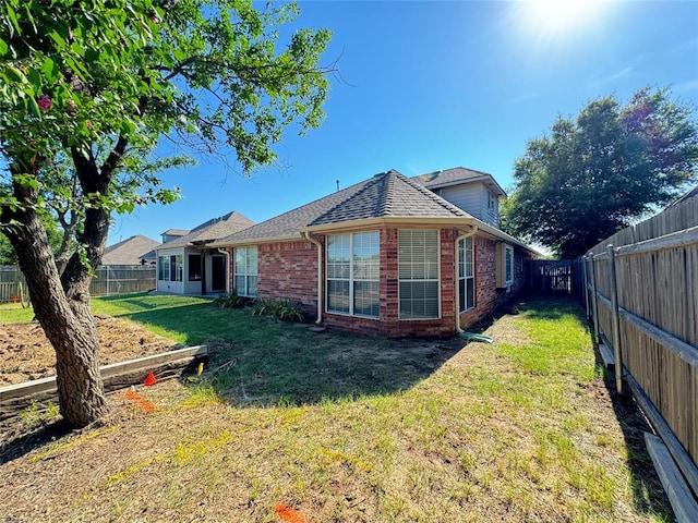 back of house with a yard