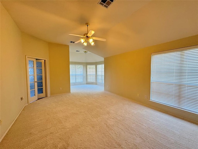 carpeted spare room featuring ceiling fan and lofted ceiling