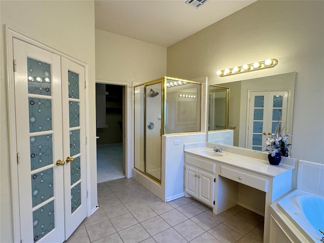 bathroom with tile patterned floors, vanity, plus walk in shower, and french doors