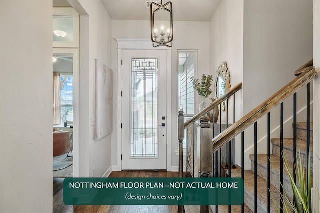 foyer featuring dark hardwood / wood-style flooring and an inviting chandelier