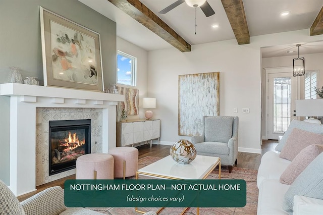 interior space with beamed ceiling, ceiling fan, dark hardwood / wood-style flooring, and a tile fireplace