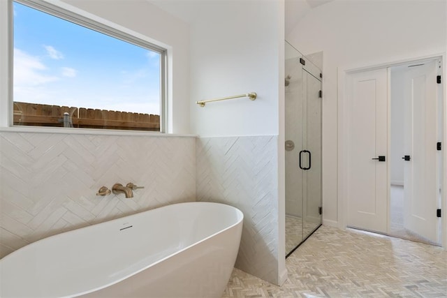 729 Caladium Dr, Yukon, OK 73099 - bathroom with a soaking tub, a stall shower, and tile walls