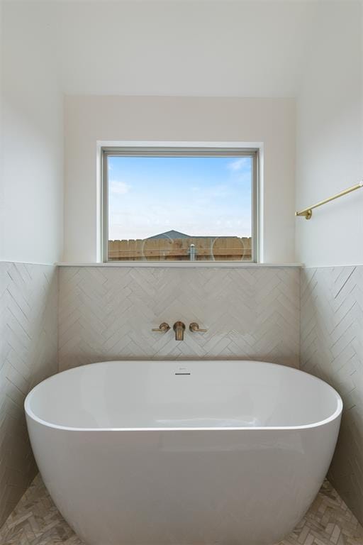 729 Caladium Dr, Yukon, OK 73099 - full bathroom featuring tile walls and a freestanding bath