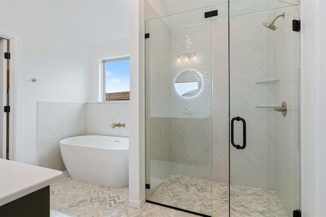 729 Caladium Dr, Yukon, OK 73099 - bathroom featuring a soaking tub, a shower stall, tile walls, and vanity