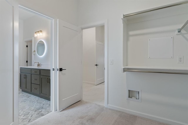 729 Caladium Dr, Yukon, OK 73099 - hallway featuring light carpet, baseboards, and a sink