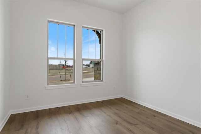 729 Caladium Dr, Yukon, OK 73099 - spare room featuring wood finished floors and baseboards