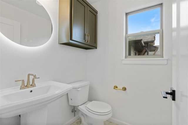 729 Caladium Dr, Yukon, OK 73099 - bathroom featuring toilet, baseboards, and a sink