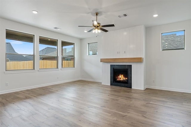 729 Caladium Dr, Yukon, OK 73099 - unfurnished living room featuring wood finished floors and visible vents