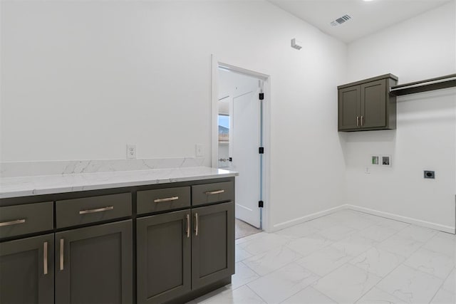 729 Caladium Dr, Yukon, OK 73099 - clothes washing area featuring electric dryer hookup, visible vents, marble finish floor, washer hookup, and cabinet space