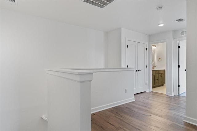 729 Caladium Dr, Yukon, OK 73099 - corridor featuring wood finished floors, visible vents, and baseboards