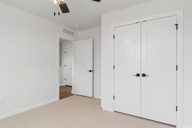 729 Caladium Dr, Yukon, OK 73099 - unfurnished bedroom with visible vents, light carpet, a closet, baseboards, and ceiling fan