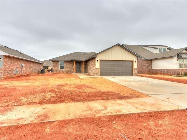 view of front of home featuring a garage, driveway, board and batten siding, and brick siding