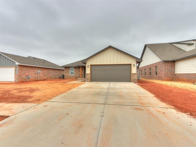 view of front of home with board and batten siding, brick siding, and an attached garage