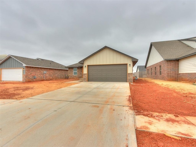 ranch-style house with board and batten siding, brick siding, and driveway