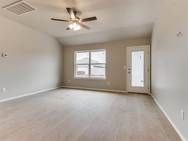 empty room featuring baseboards, visible vents, a ceiling fan, lofted ceiling, and light wood-style floors