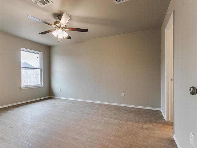 unfurnished room with visible vents, ceiling fan, and baseboards