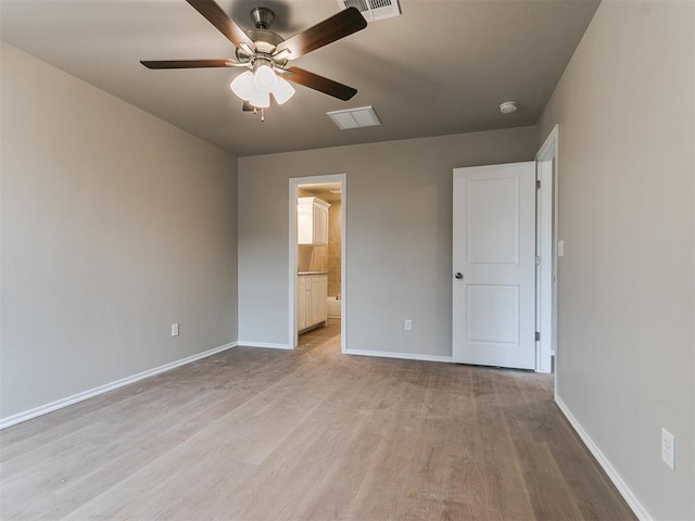 unfurnished bedroom featuring visible vents, baseboards, connected bathroom, light wood-style flooring, and ceiling fan