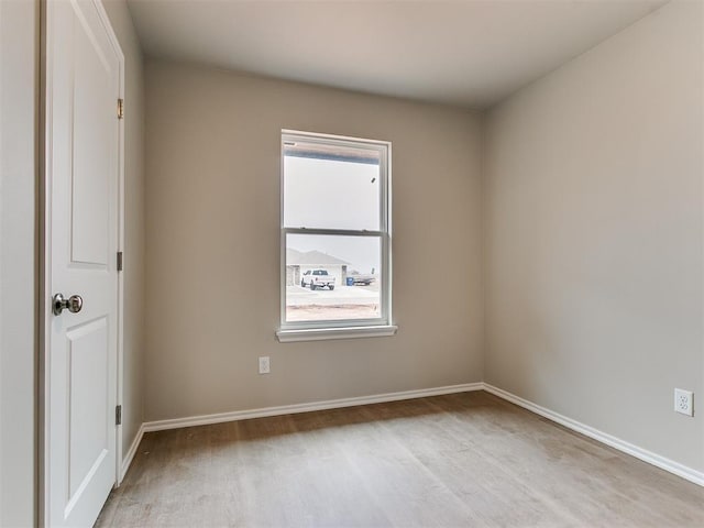 unfurnished room featuring wood finished floors and baseboards