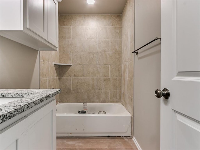 full bath with shower / bath combination, wood finished floors, and vanity