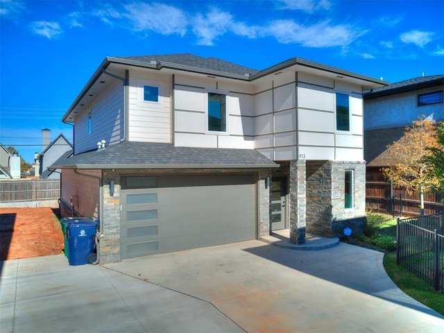913 NW 43rd St, Oklahoma City, OK 73118 - contemporary home featuring concrete driveway, stone siding, a garage, and roof with shingles