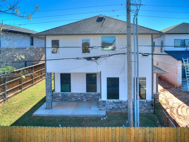 913 NW 43rd St, Oklahoma City, OK 73118 - back of property featuring a fenced backyard, a shingled roof, and a patio area