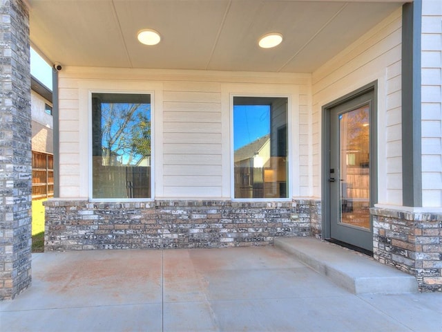 913 NW 43rd St, Oklahoma City, OK 73118 - doorway to property featuring a patio area and stone siding
