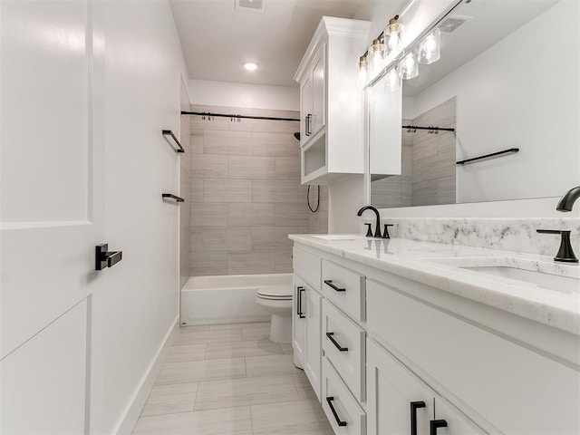 full bathroom featuring vanity, toilet, and tiled shower / bath combo