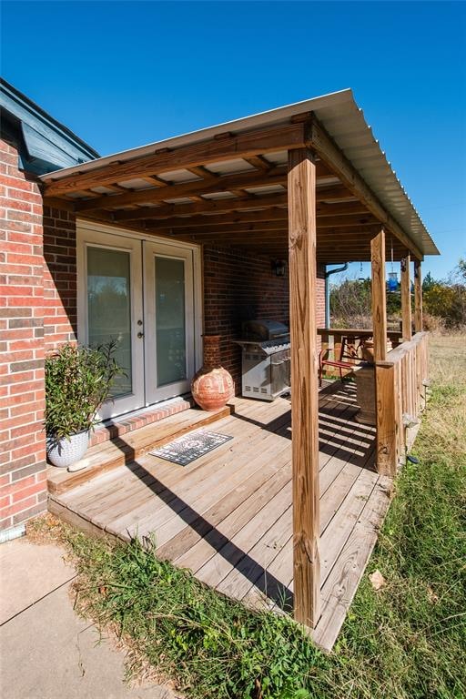 deck featuring french doors and a grill