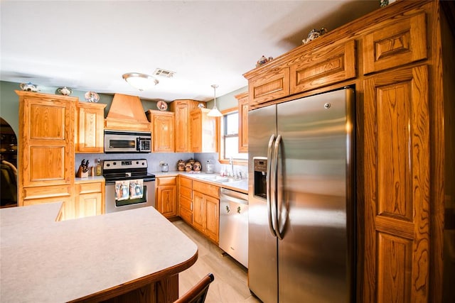 kitchen with sink, backsplash, light hardwood / wood-style floors, pendant lighting, and appliances with stainless steel finishes