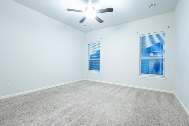 carpeted spare room with ceiling fan