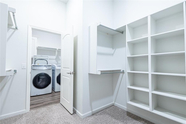 spacious closet with washer and dryer and carpet