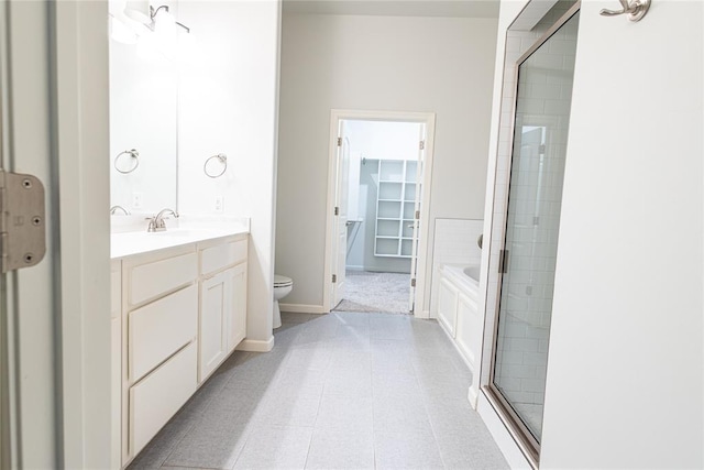 bathroom with vanity, toilet, and walk in shower