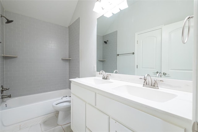 full bathroom with tiled shower / bath, vaulted ceiling, vanity, and toilet