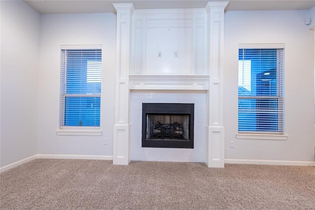 unfurnished living room with carpet floors and ornate columns