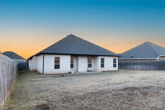 view of back house at dusk