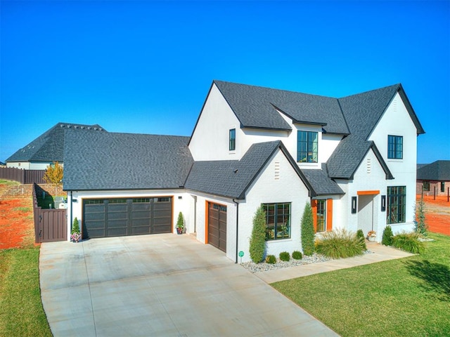 modern farmhouse style home featuring a front lawn and a garage