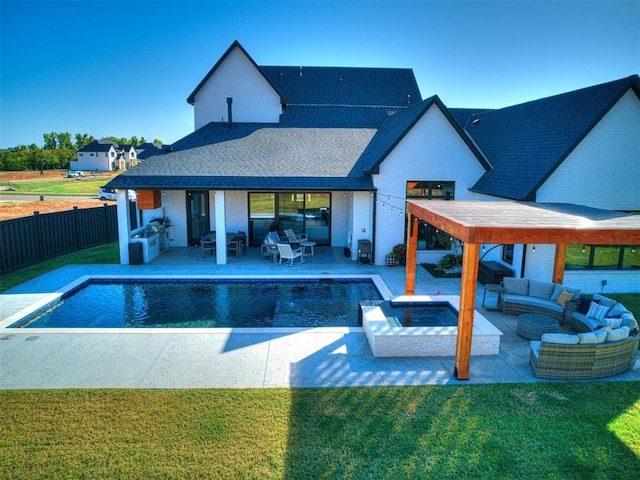 view of pool featuring outdoor lounge area, a patio area, and a lawn