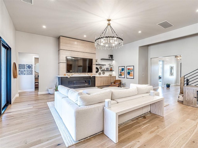 living room with a notable chandelier and light hardwood / wood-style floors