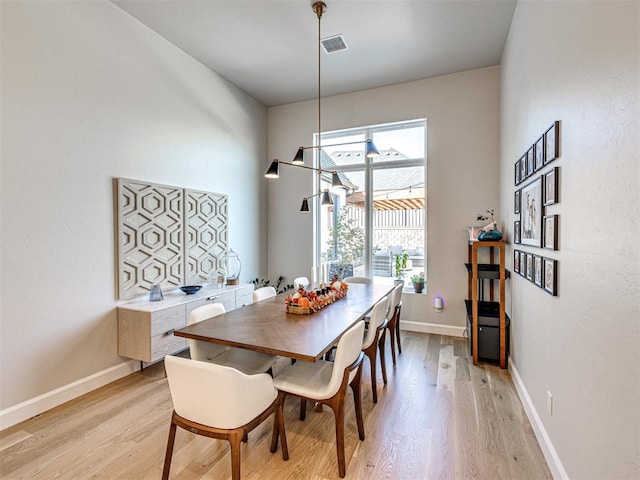 dining space with light wood-type flooring