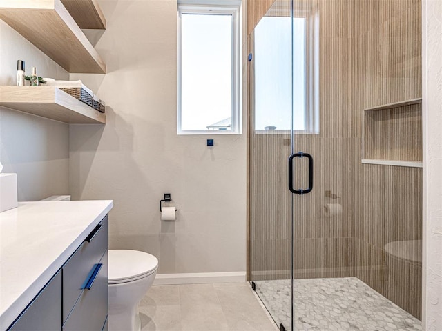 bathroom featuring a shower with door, vanity, and toilet