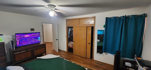 bedroom with ceiling fan and dark hardwood / wood-style floors