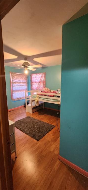 bedroom with hardwood / wood-style floors and ceiling fan